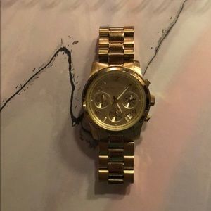 Gold women’s Michael Kors watch